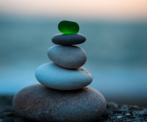 Calm scene with stacked stones symbolizing balance and wellness.